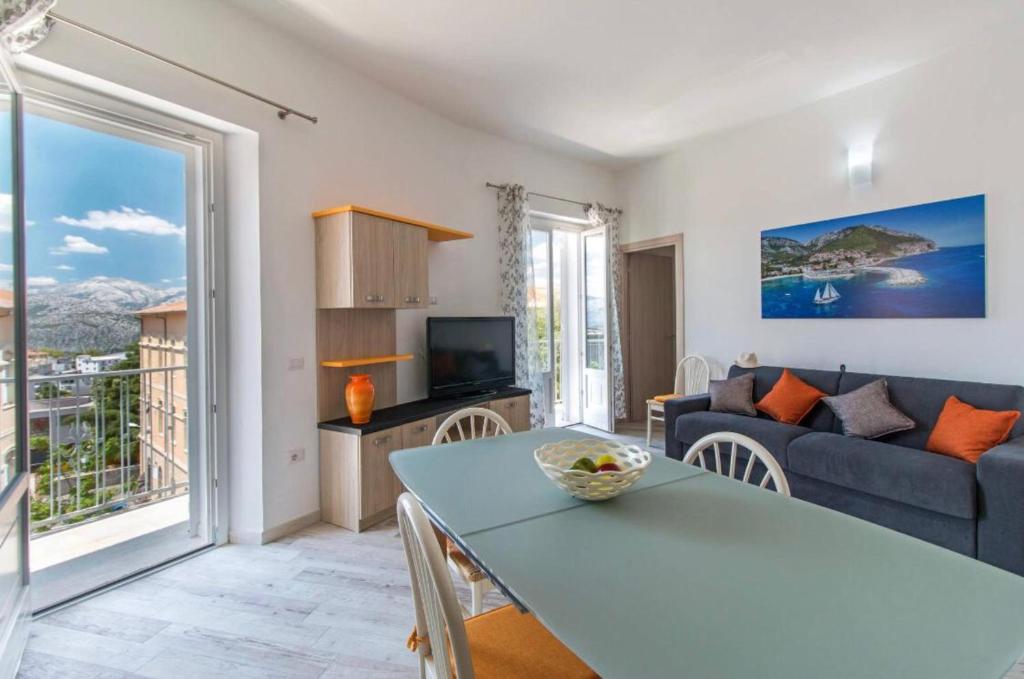 a living room with a couch and a table at Appartamento Castula in Dorgali