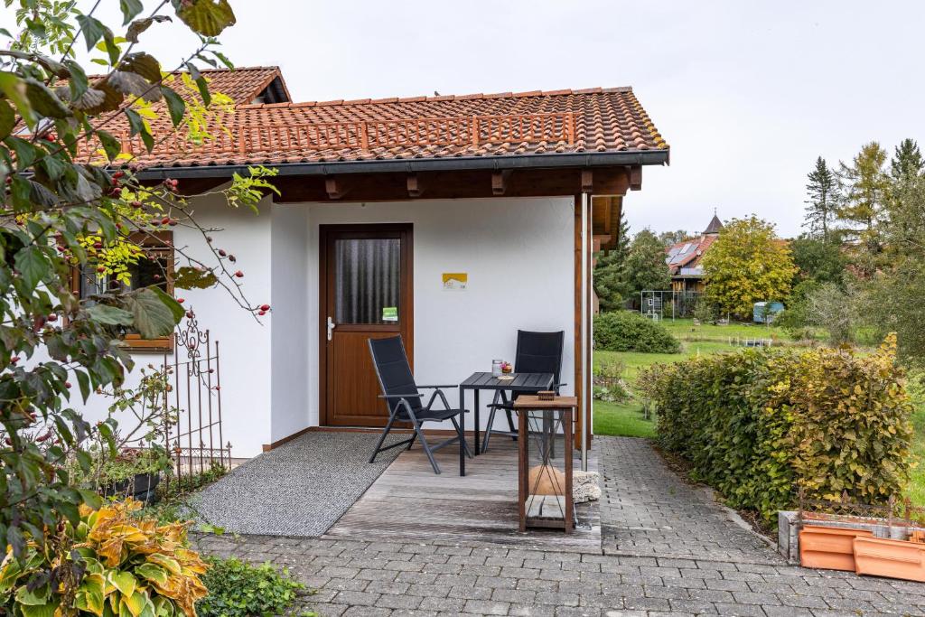 a small house with a table and chairs on a patio at Ferienhaus Katrin in Bad Urach
