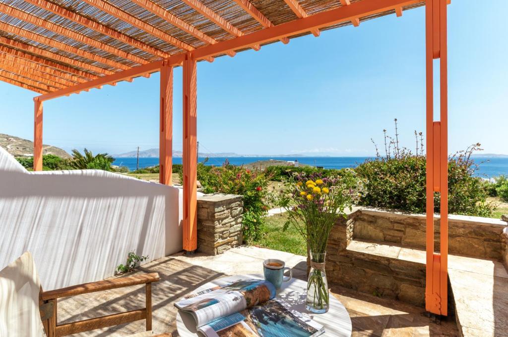 a patio with a table and a view of the ocean at Anemologio 202 Studio Tinos in Agios Ioannis