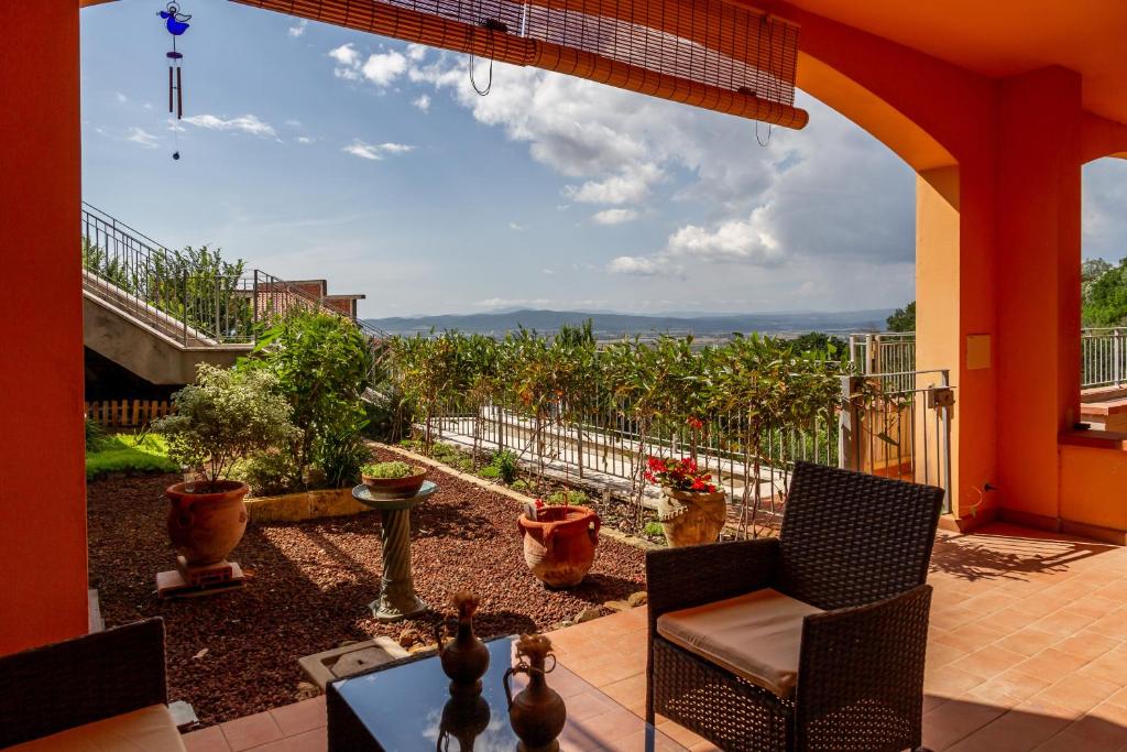 a patio with chairs and a view of a garden at Belvedere in Scarlino