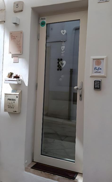 a door in a room with a glass door sidx sidx sidx at Dimora Giulia in Castellana Grotte