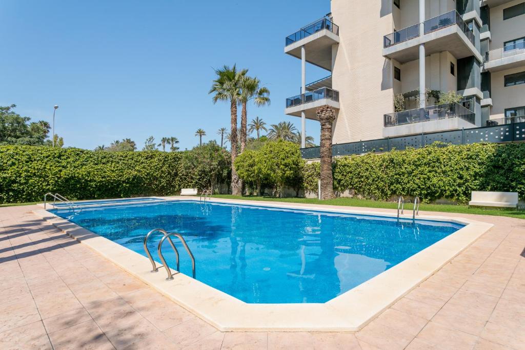 a swimming pool in front of a building at Boliche in Benimagrell