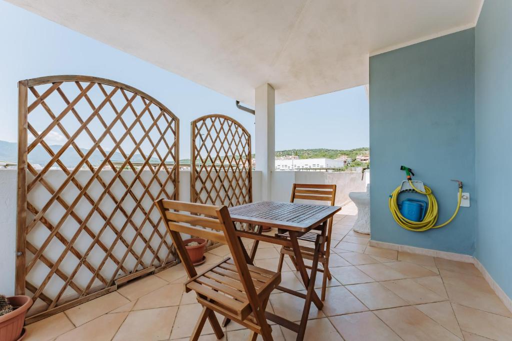 a table and chairs in a room with a view of the ocean at Casa Perla in Villasimius