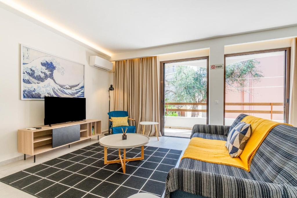 a living room with a couch and a tv at Eirini's Apartment in Kanoni