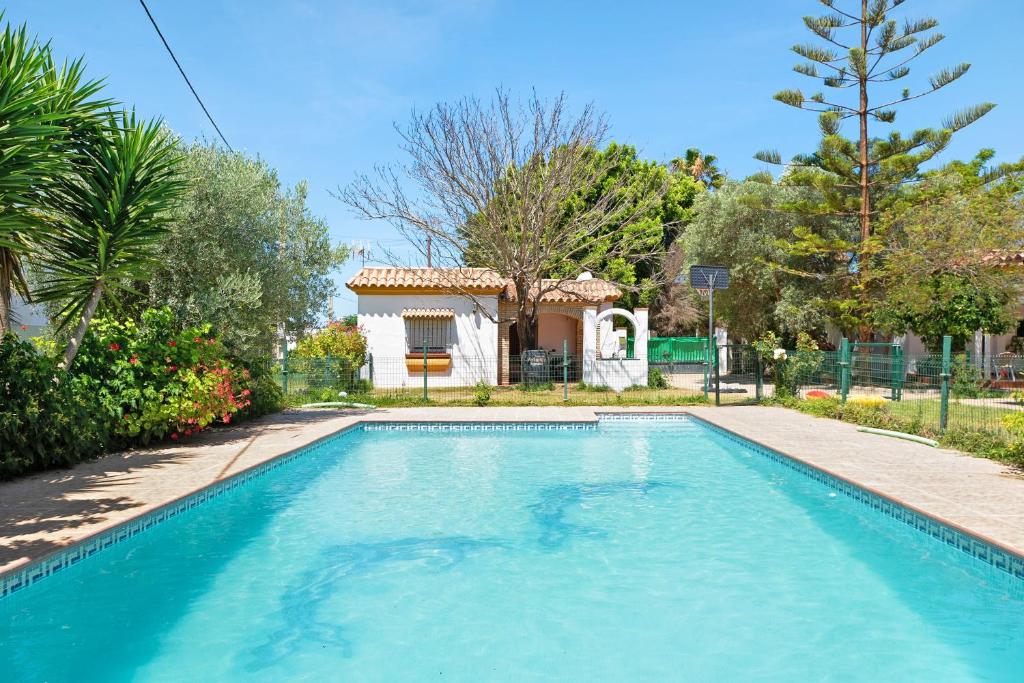 a swimming pool in front of a house at Casa Paqui 1 in Roche