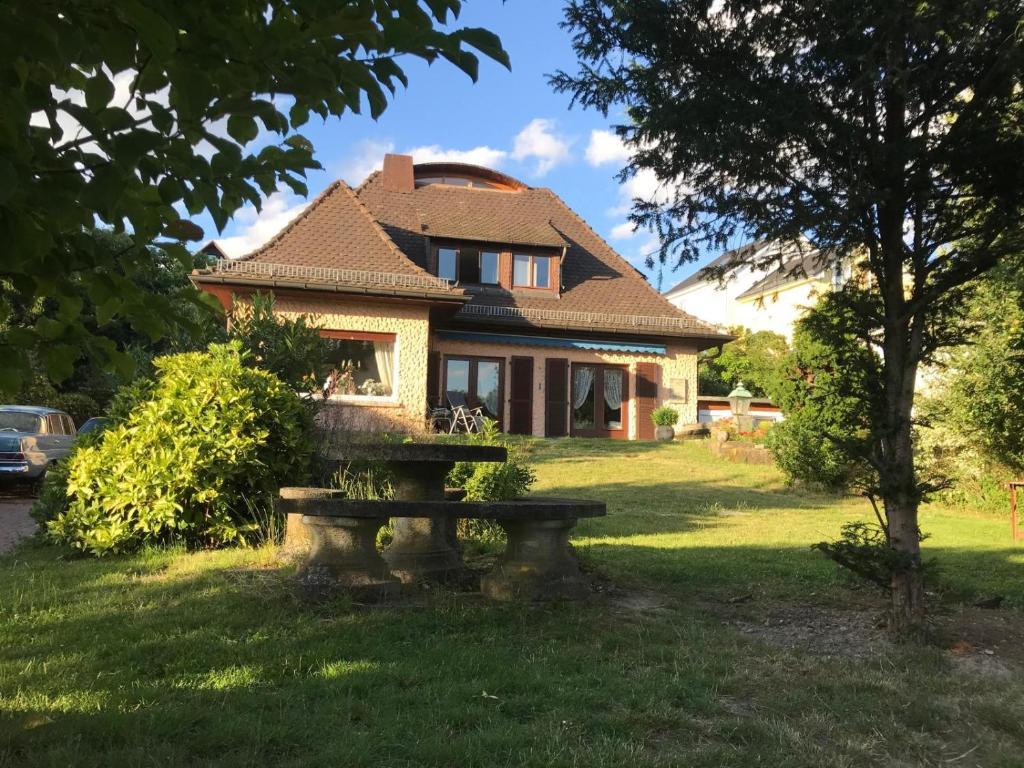 a house with a bench in front of it at Green wonder in Friedrichsdorf