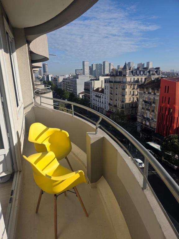 a yellow chair sitting on top of a balcony at Paris vous aime in Le Kremlin-Bicêtre