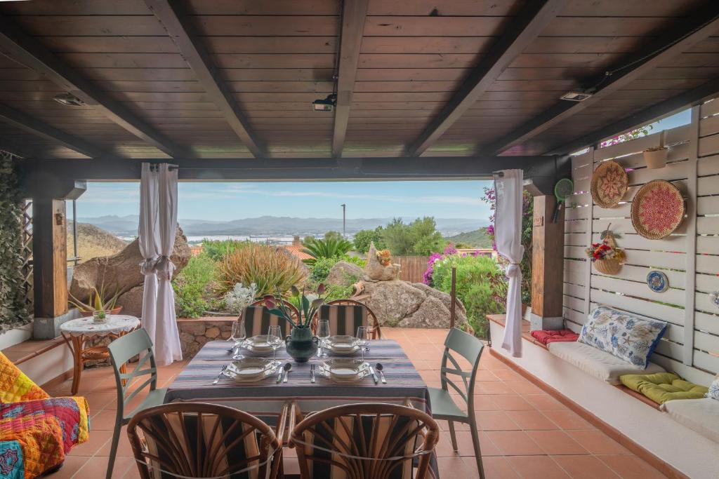 a patio with a table and chairs and a couch at Rosemary House in Olbia