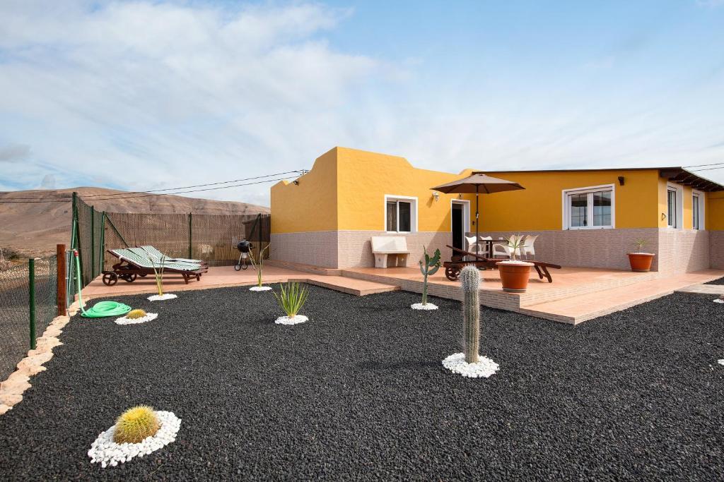 a house in the desert with a yard with plants at Casa Cactus in Antigua