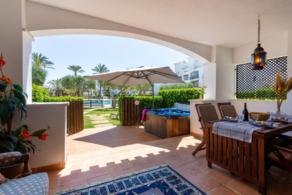a patio with a table and an umbrella at Luxury Pool and Spa - Casa Coco in Casas del Cura