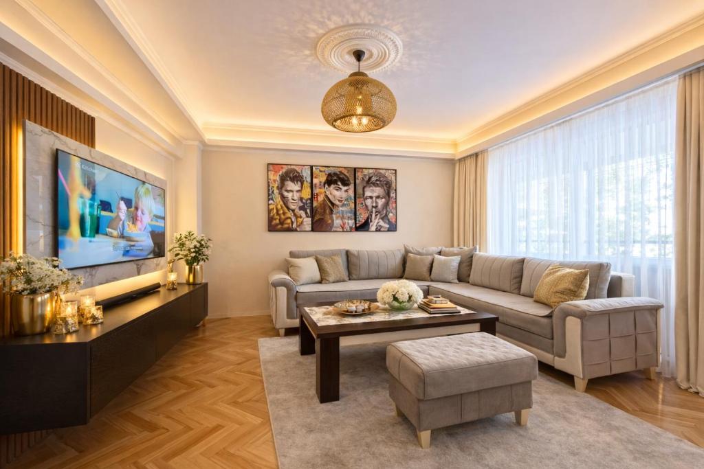 a living room with a couch and a tv at Mitrovi Apartment in Gevgelija