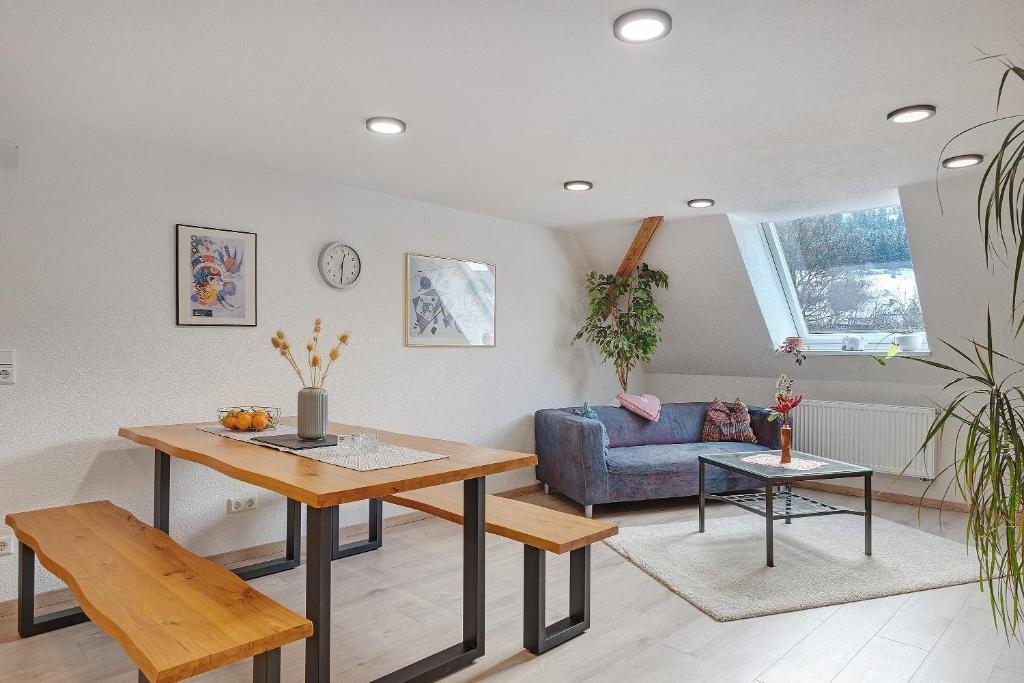 a living room with a table and a blue couch at Haus an der Breg in Vöhrenbach