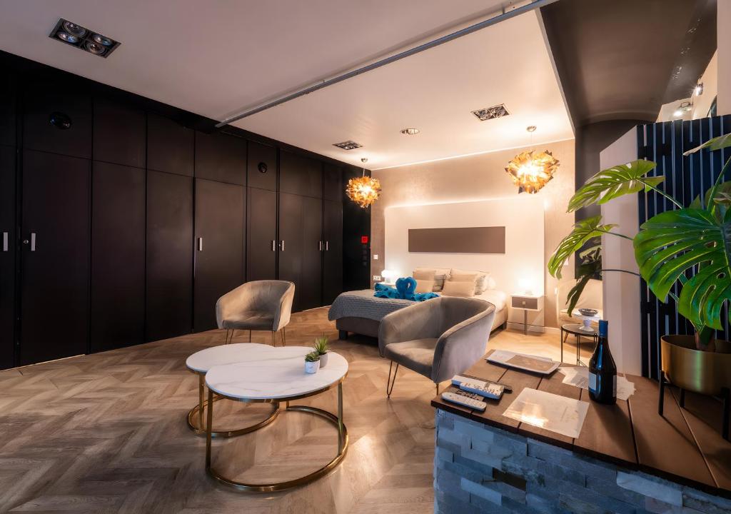 a living room with a couch and a table at Suite toute équipée Jacuzzi privé in Nîmes