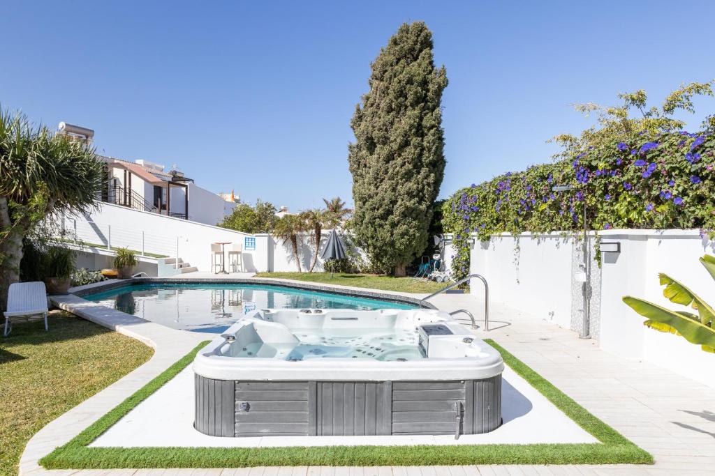a hot tub in a yard next to a swimming pool at San Jose in Nerja