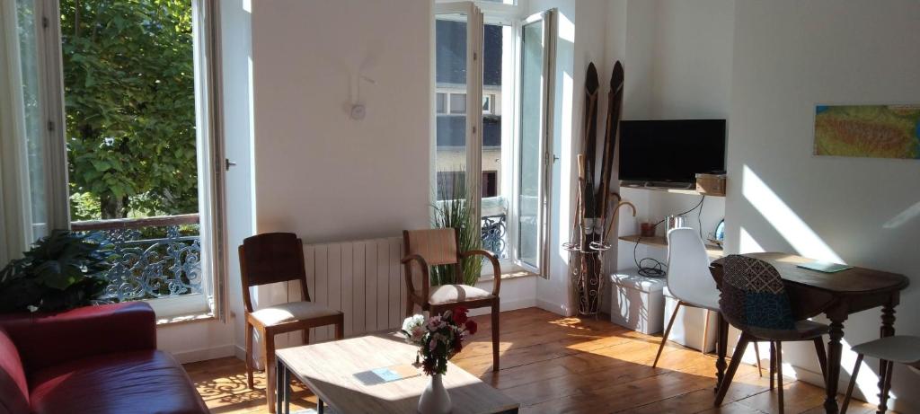 a living room with a couch and a table at T2 bis Vue Aneto in Luchon