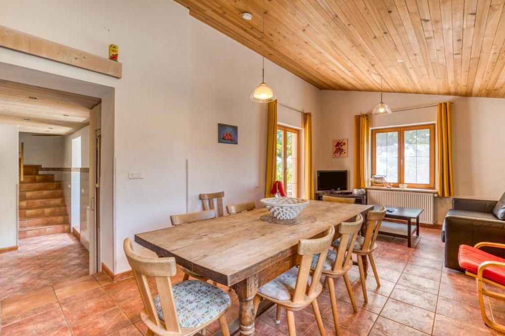 a dining room with a wooden table and chairs at Maison Orange in Aspiran