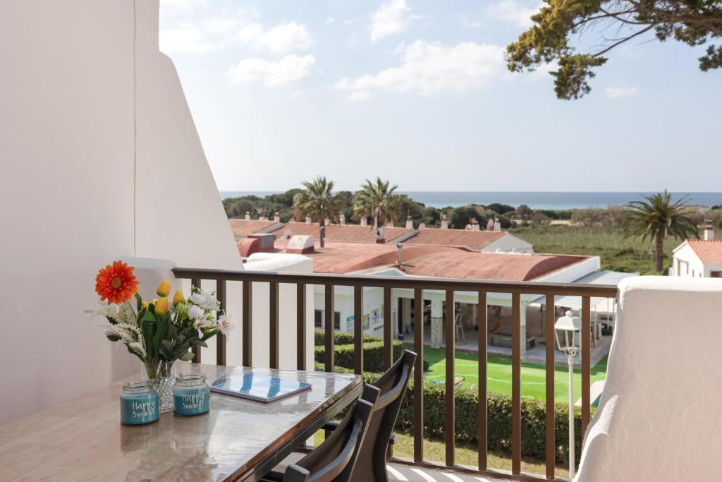 a balcony with a table and chairs and a view of the ocean at Safir in Son Bou