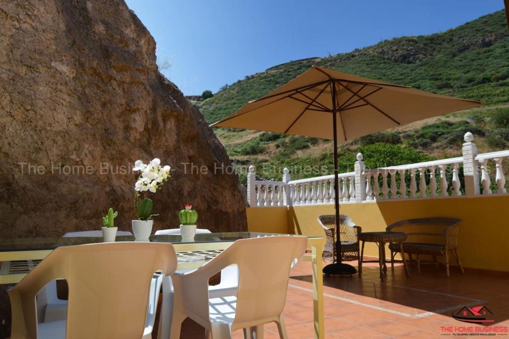 a patio with a table and an umbrella at Villa Palomino in Gáldar