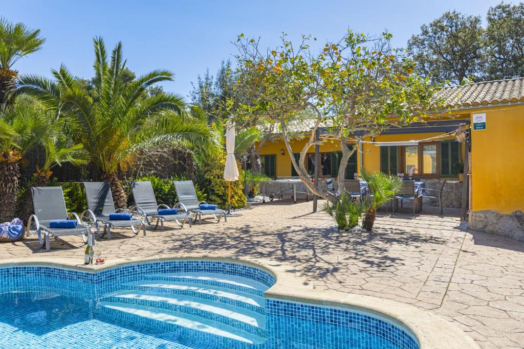 a swimming pool in front of a house at Villa El Mal Pas / Can Seguinet in Alcudia