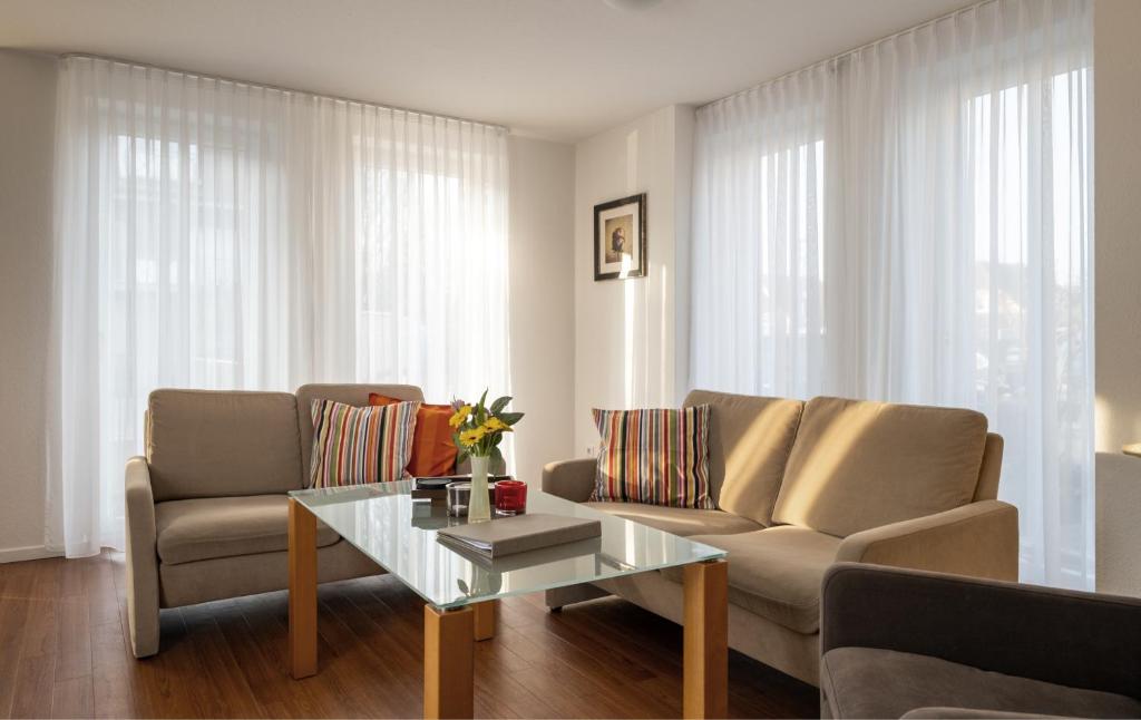 a living room with a couch and a coffee table at Ferienhaus Jümmers - Hein Mück in Horumersiel