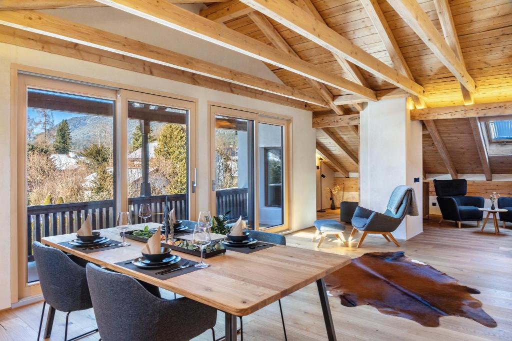 a dining room with a wooden table and chairs at Alpview Loft Garmisch in Garmisch-Partenkirchen
