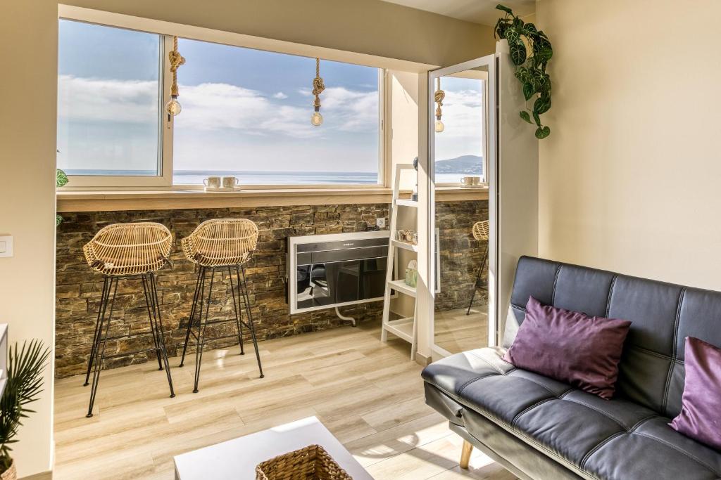 a living room with a couch and a fireplace at Atic Moon Miami in Empuriabrava