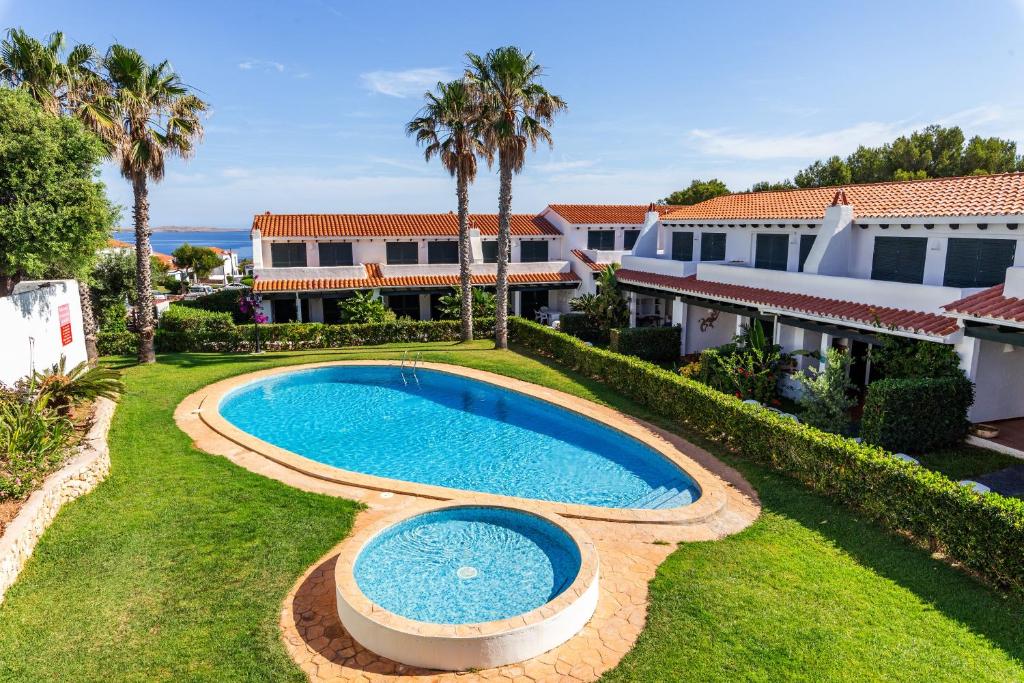 a swimming pool in the yard of a house at Maison Menorca in Arenal d'en Castell