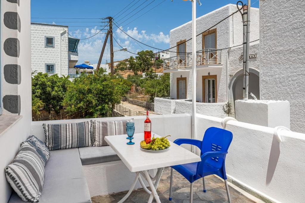 a white balcony with a table and chairs and a view at Pico Bello Patmos 26 in Patmos