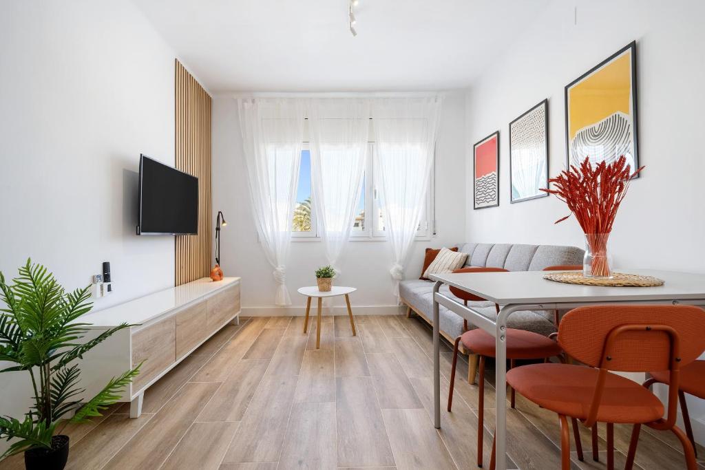 a living room with a table and a couch at The Sunset Calafell in Calafell