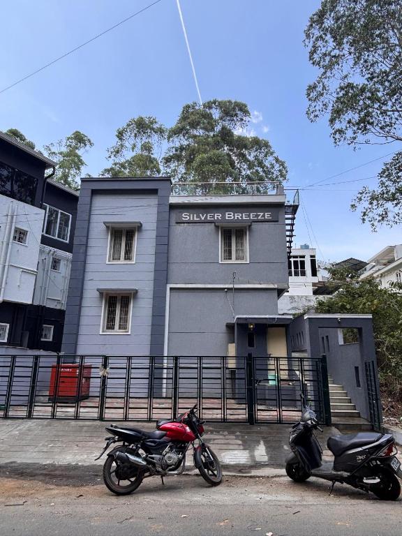two motorcycles parked in front of a building at Silver Breeze in Yercaud