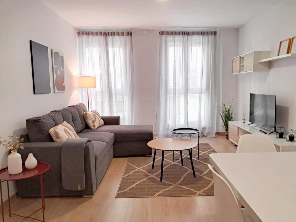 a living room with a couch and a table at Apartamentos PORTA NOVA 2 in Lugo