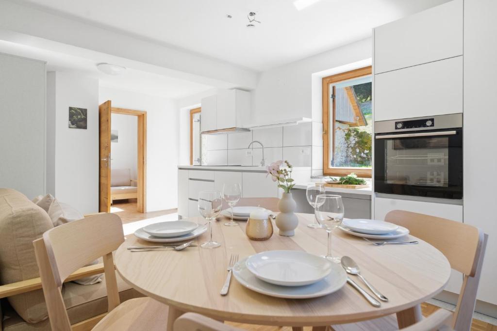 a kitchen and dining room with a table and chairs at Mini Trenta in Soča
