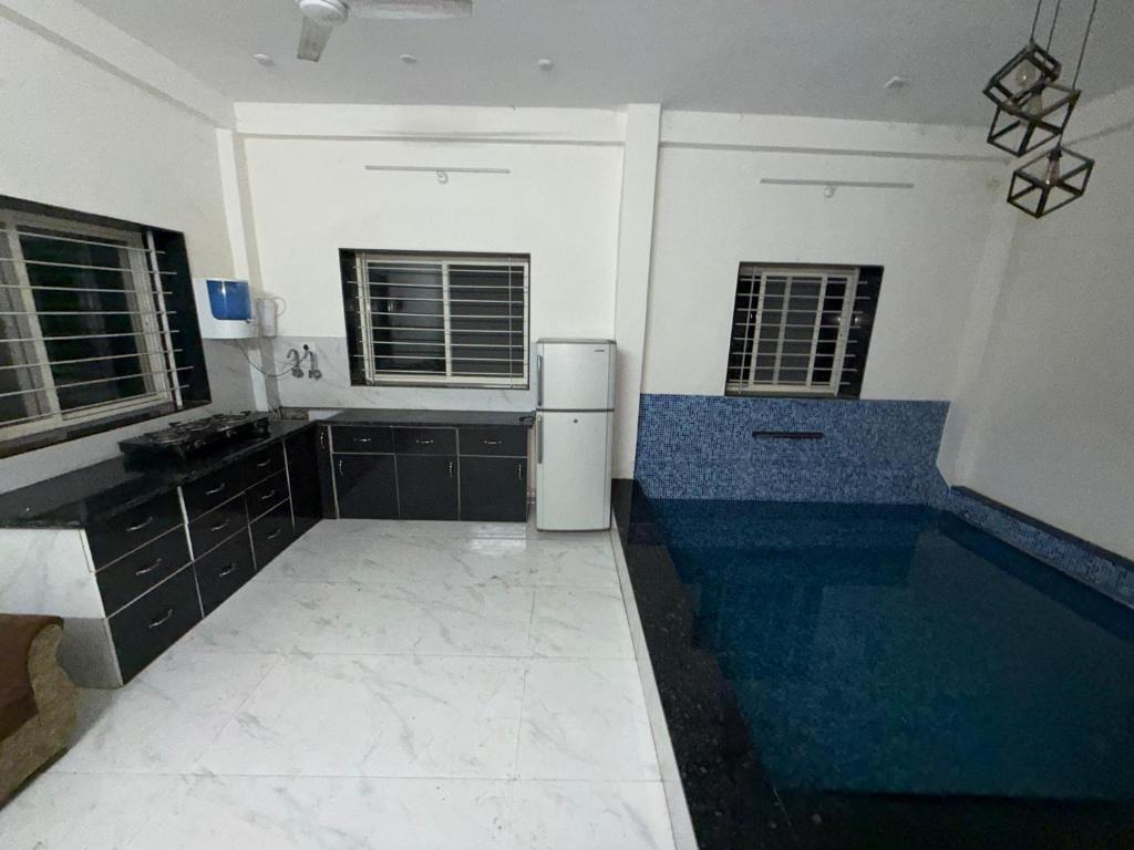 a kitchen with a sink and a refrigerator at Nahta's Farm Villa in Simrol
