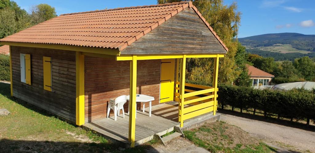 a small shed with a table and a table at 7 Chalet Mimosa in Blavignac