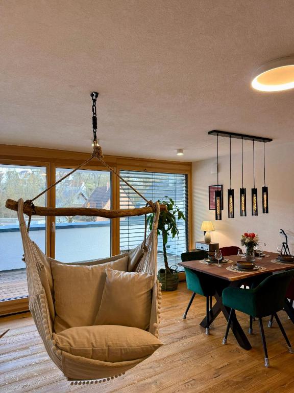 a hammock hanging in a living room with a table at Hangout in Neckartenzlingen