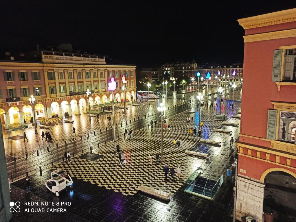 a city street at night with people walking around at Lovely view in Nice