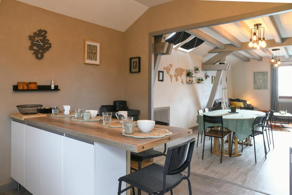 a kitchen and dining room with a table and chairs at Reflets De Montagnes in Chambéry
