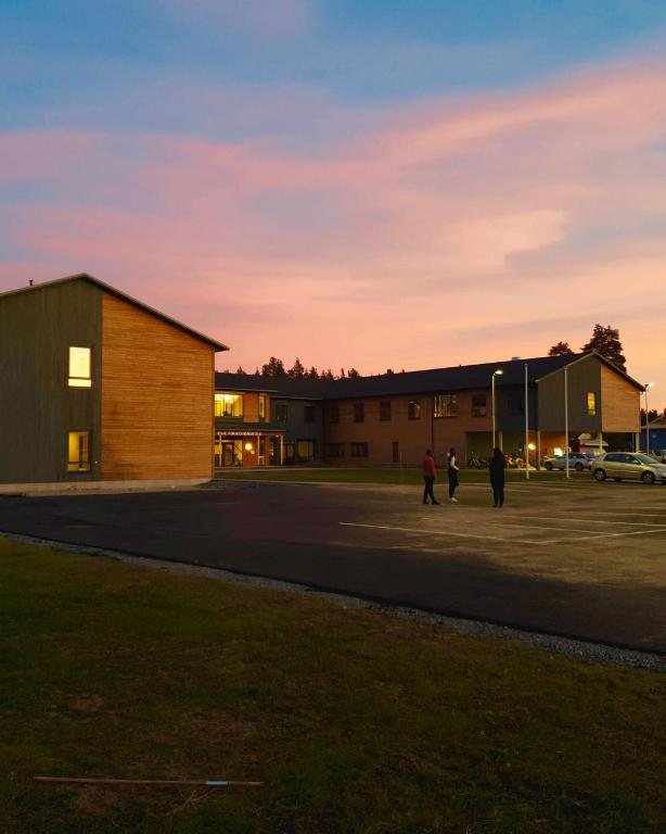 a group of people standing outside of a building at Evje Folkehøgskole in Evjemoen