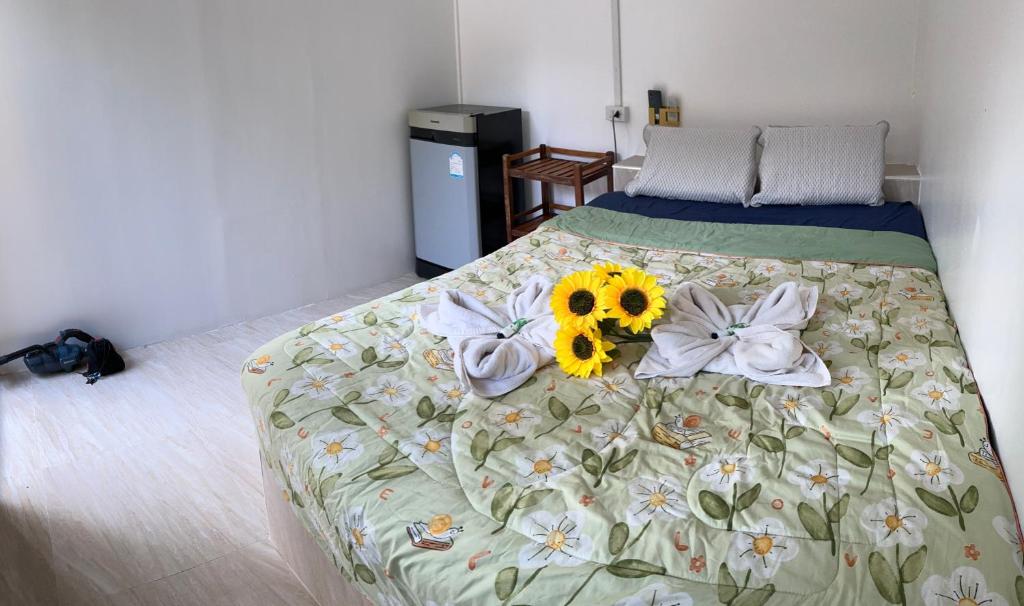 a bedroom with a bed with flowers on it at elephant garden in Ban Bang Bao