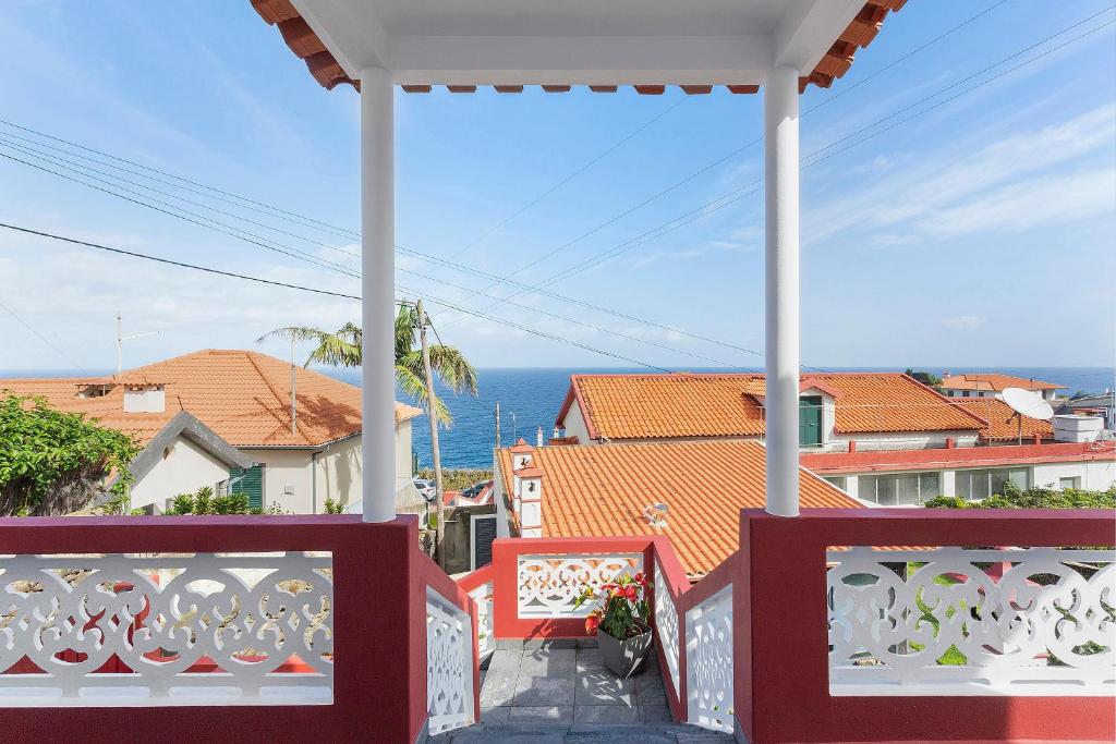 a balcony with a view of the ocean and buildings at Casa Da Avó Ferreirinha in Seixal