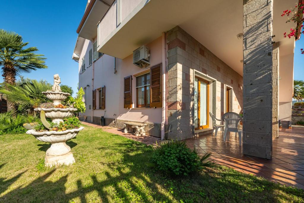 a large stone fountain in the yard of a house at Su Suergiu in San Giovanni Suergiu