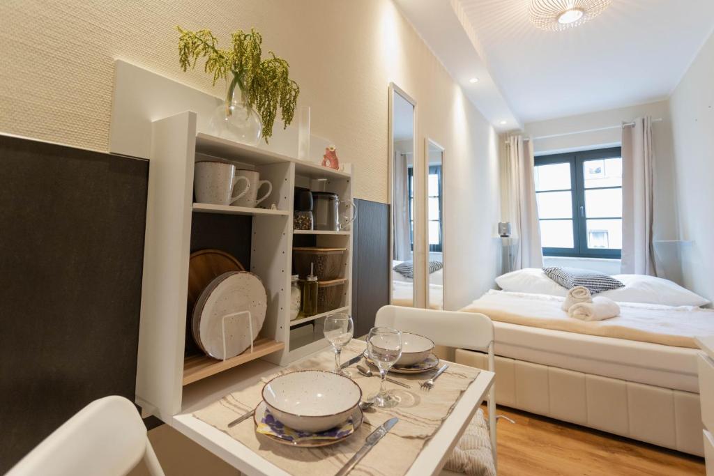 a room with a bed and a table with glasses on it at Ferienwohnung Baltic in Barth