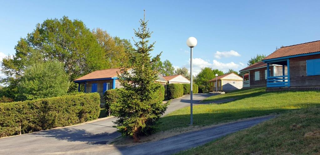 a house with a street light next to a driveway at 8 Chalet Genet in Blavignac