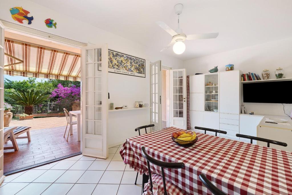 a kitchen and a dining room with a table and chairs at Casa Ghibli in Loano