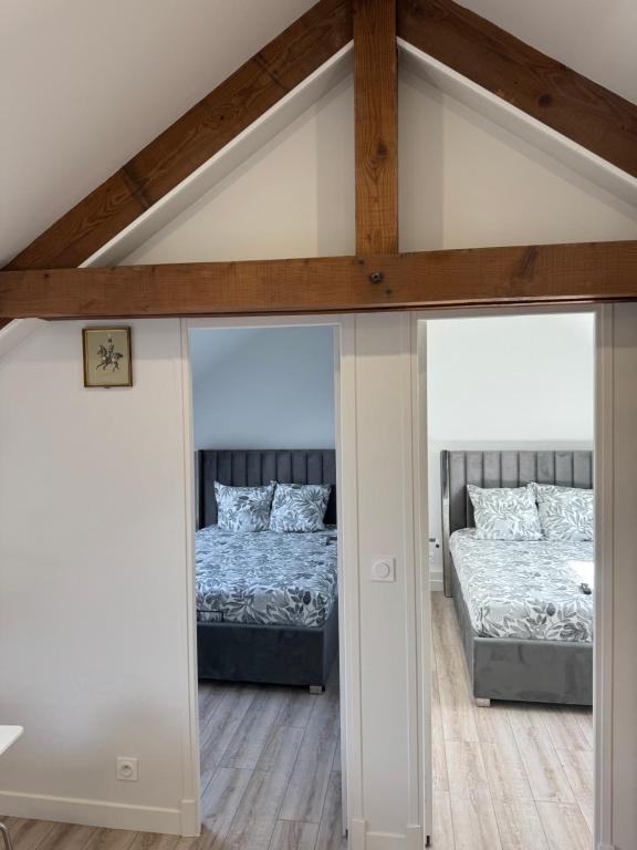 a room with two beds and two windows at Appartement 4 morangis in Morangis