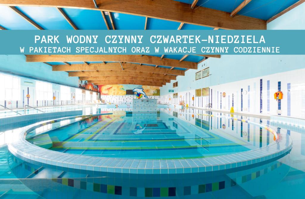 a swimming pool at a park worshipary caryaryawarawarawarawar hospital at Hotel Jan in Darlowko
