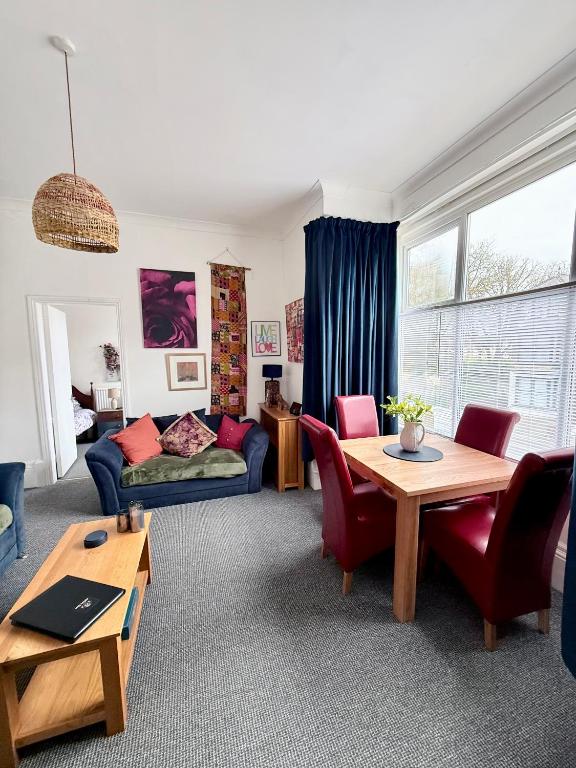 a living room with a couch and a table at Alfie's Den, Bridlington in Bridlington