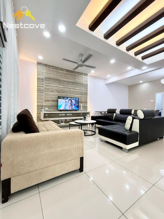 a living room with two couches and a flat screen tv at The Single Level Bliss By Nestcove in Malacca