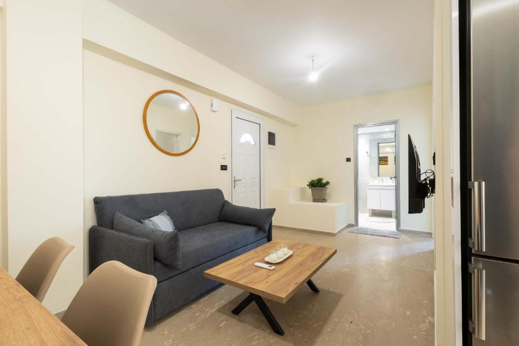 a living room with a couch and a table at Sinani Apartment - Sea View Balcony & Jacuzzi Gem in Asgourou