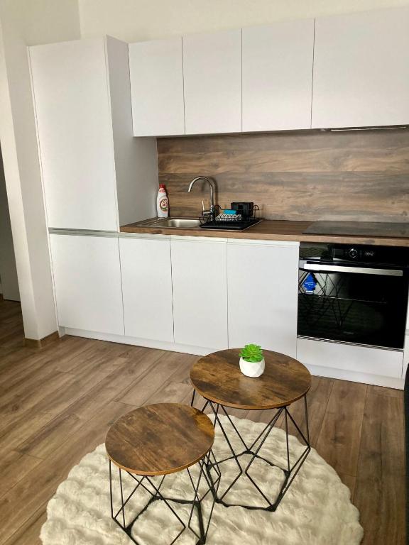 a kitchen with a table and two chairs and a sink at Apartment Poprad in Poprad